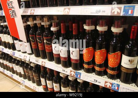 --FILE--Bottles of red wine imported from France are displayed for sale at a supermarket in Xuchang, central Chinas Henan province, 16 June 2013.   Do Stock Photo