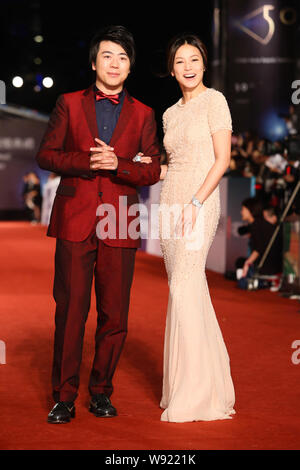 Chinese pianist Lang Lang, left, and Hong Kong singer Denise Ho pose on the red carpet as they arrive at the 50th Golden Horse Awards ceremony in Taip Stock Photo