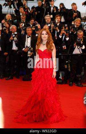 Australian actress Isla Fisher poses on the red carpet as she arrives for the opening ceremony of the 66th Cannes International Film Festival and the Stock Photo