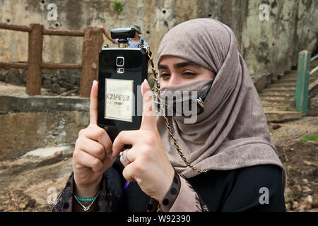 WOMAN WEARING A NIQAB VEIL AND A SMARTPHONE IN SRI LANKA Stock Photo