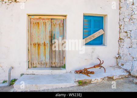 Street view of Potamos village with narrow alleys and traditional architecture in Antikythera island in Greece Stock Photo