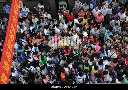 Chinese parents wait for their children walking out of a middel school after an examination of the annual national college entrance exam, also known a Stock Photo