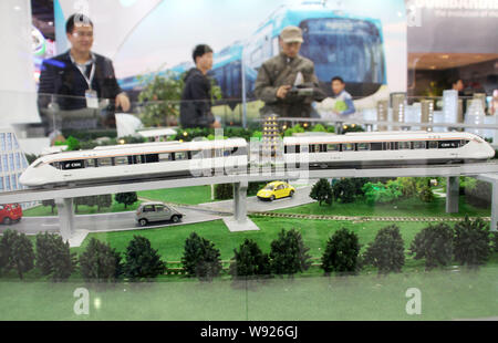 --FILE--Chinese visitors look at models of CRH (China Railway High-speed) trains during the METRO CHINA 2013 exhibition in Beijing, China, 19 November Stock Photo