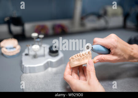 Dental technician preparing prosthesis for the patient. Stock Photo