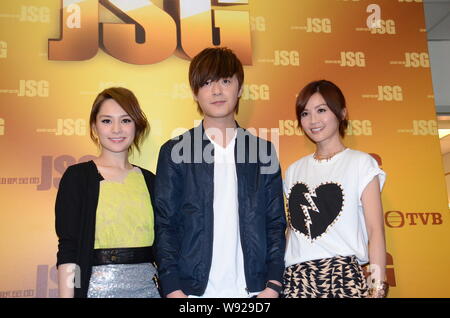 Gillian Chung, left, and Charlene Choi, right, of Hong Kong pop duo Twins pose with Hong Kong singer Ken Hung, center, as they arrive for a filming se Stock Photo