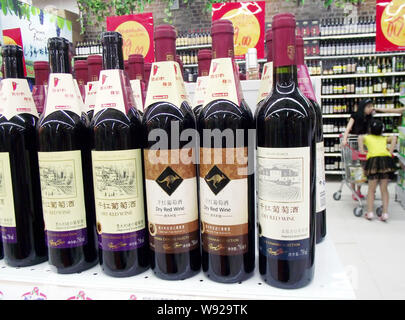 --FILE--Bottles of wine imported from France, Australia and Italy are displayed for sale at a supermarket in Nanjing, east Chinas Jiangsu province, 23 Stock Photo