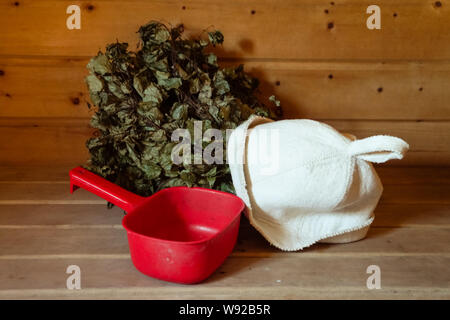 Still life in a bath of the bucket, birch broom, and hats for soaring. Rest in a Russian bath. Stock Photo