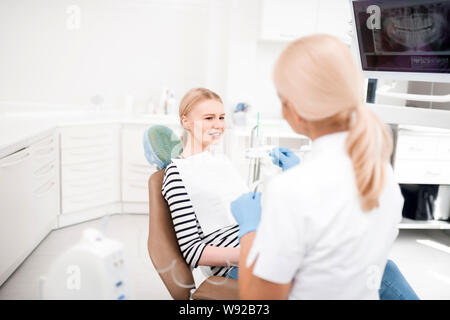 Patient being confused sitting at dentists office. Stock Photo