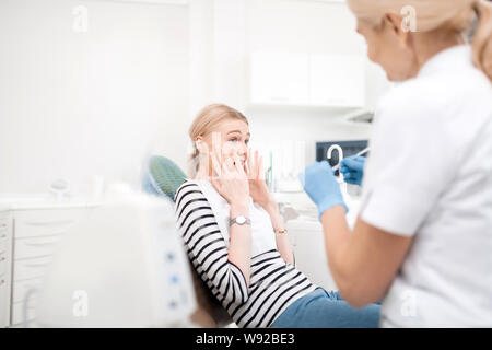 Dentists young patient being scared of dental treatment. Stock Photo