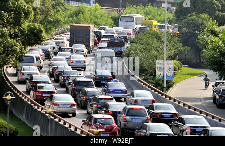 --FILE--Vehicles move slowly in a traffic jam on a ramp to an elevated highway in Shanghai, China, 21 June 2012.   Shanghai is considering introducing Stock Photo