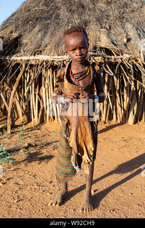 Turmi, Omo River Valley, Ethiopia - May 10, 2019: Portrait of a Hamar children in village. The Hamer are a primitive tribe and the women have many dec Stock Photo