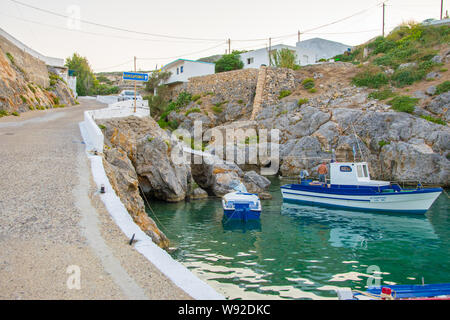 Potamos village with the port and the traditional white houses with blue windows in Antikythera island in Greece Stock Photo