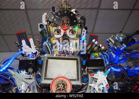 The robot made from scrap by Chinese farmer Tao Xiangli is displayed at his home in Beijing, China, 16 May 2013.   Tao Xiangli, a 37-year-old inventor Stock Photo