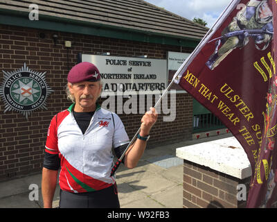 A man who declined to be named but described himself as a former member of 1 Para (1st Battalion of Parachute Regiment) holds a silent protest at policing actions in Derry on Saturday outside Police Service of Northern Ireland HQ in Belfast. Stock Photo