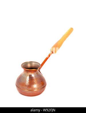 Small copper cezve for making Turkish coffee on a white background. No ornament. Wooden handle. Close up, isolate. Side view Stock Photo