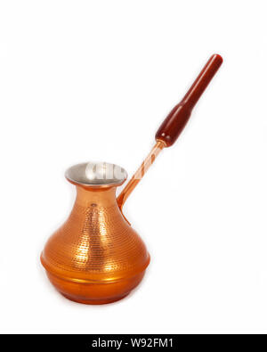 Medium-sized cezve for brewing Turkish coffee on a white background. Copper cezve without ornament. Turkish coffee. Close up, side view. Isolate Stock Photo