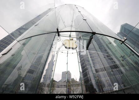 --FILE--The logo of Apple is pictured at the Apple Store next to the twin towers of the International Finance Center (IFC) in the Lujiazui Financial D Stock Photo