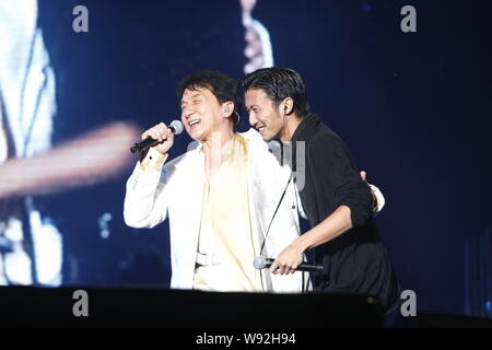 Hong Kong actor and singer Jackie Chan, left, performs with Hong Kong actor and singer Nicholas Tse during Chans concert in Hangzhou, east Chinas Zhej Stock Photo