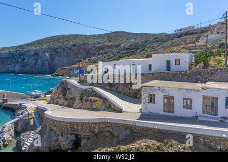 Potamos village with the port and the colorful fishing boats sailing in the turquoise sea waters in Antikythera island in Greece Stock Photo