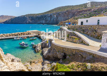 Potamos village with the port and the colorful fishing boats sailing in the turquoise sea waters in Antikythera island in Greece Stock Photo