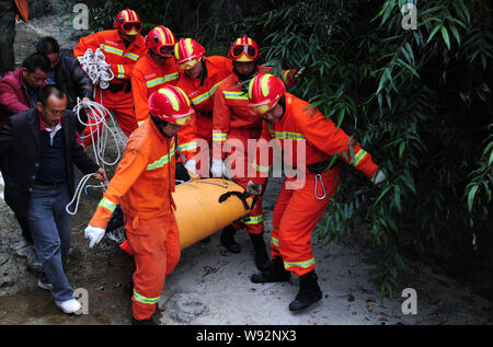 Chinese rescuers carry the body of Hungarian wingsuit flier Viktor Kovats after he died in an accident during a jump at Tianmen Mountain National Fore Stock Photo