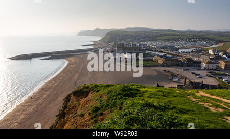 The River Brit flows into Lyme Bay at Bridport's West Bay harbour on Dorset's Jurassic Coast. Stock Photo