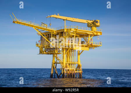 Oil and gas wellhead remote platform produced raw gas and oil then sent to central processing platform to seperate water,gas and condensate ( Crude oi Stock Photo