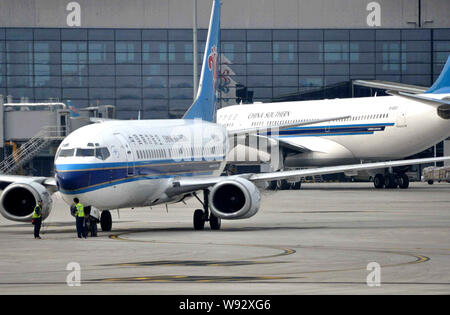 --FILE--Boeing 737-300, front, and Airbus A330-200 jet planes of China Southern Airlines are pictured at Shanghai Hongqiao International Airport in Sh Stock Photo