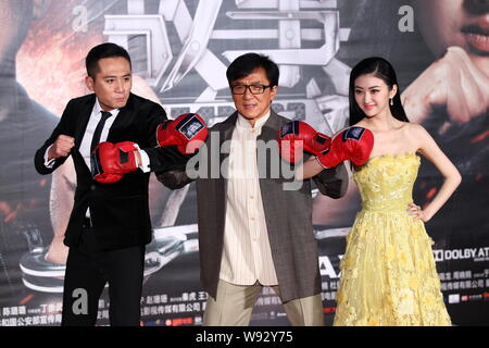 (From left) Chinese actor Liu Ye, Hong Kong actor Jackie Chan and Chinese actress Jing Tian pose at a premiere for their new movie, Police Story 2013, Stock Photo