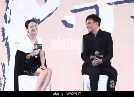 Chinese actress Zhang Ziyi (left) and Taiwanese actor Zhang Zhen talk about their latest movie, The Grandmaster, during the premiere in Beijing, China Stock Photo