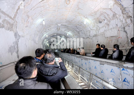 Tourists ride escalators through Mount Tianmen at Tianmen Mountain National Forest Park in Zhangjiajie city, central Chinas Hunan province, 28 Decembe Stock Photo