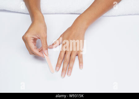 Woman filing her fingernails, female natural manicure nail grooming Stock Photo