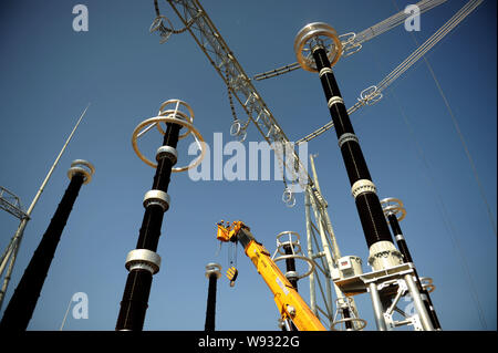 --FILE--Chinese electricians install electricity transmission devices at a UHV (Ultra High Voltage) transformer station in Anji county, Huzhou city, e Stock Photo