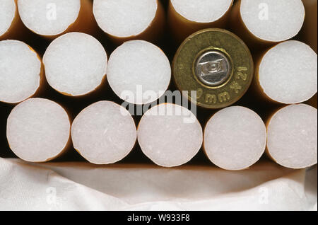bullet in cigarette pack Stock Photo