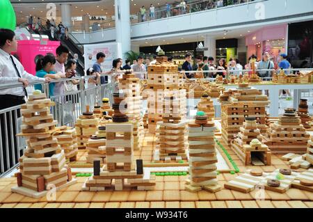 Visitors look at miniature buildings made of biscuits, wafers, candies and chocolate at the Palace 66 shopping Mall in Shenyang city, northeast Chinas Stock Photo