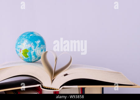 World Teacher's Day. Globe and book an open book over white background. Stock Photo