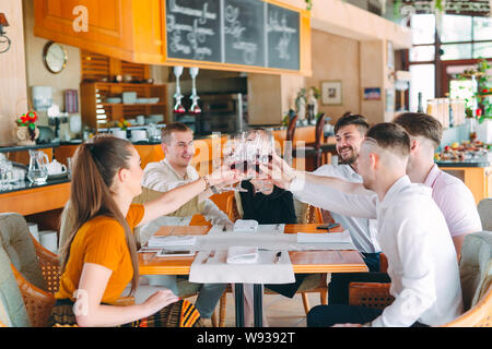 Friends drink wine on the terrace of the restaurant. Stock Photo