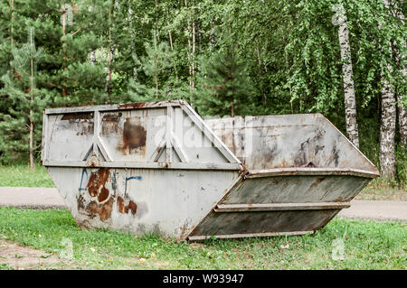 Dumpster in park. One garbage in forest on the grass Stock Photo