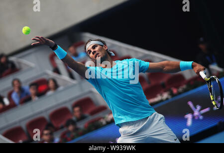 Rafael Nadal of Spain returns a shot to Tomas Berdych of the Czech Republic during the semifinal match at the China Open tennis tournament at the Nati Stock Photo