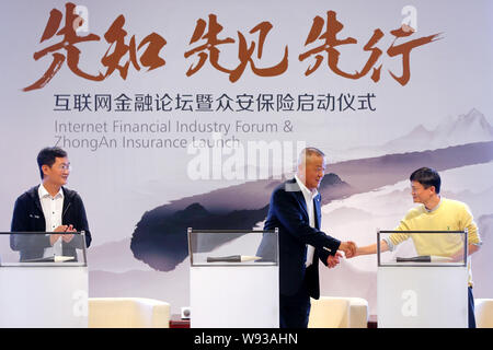 Jack Ma Yun, right, Chairman of Alibaba Group, shakes hands with Ma Mingzhe, center, Chairman of Ping An Insurance (Group) Company of China, Ltd., nex Stock Photo