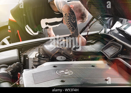 Moscow, Russia - July 30, 2019: Open car engine hood. Checking the condition of the engine, an electronic system to carefully check the damage, to rep Stock Photo