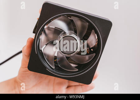 Valencia, Spain - August 11, 2019: Hand holding AMD Ryzen 3000 prism CPU fan.  Zen 2 launch. Isolated on white. Stock Photo