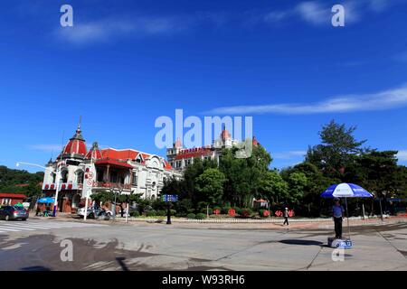 --FILE--A Chinese police officer directs traffic at a crossroad in Beidaihe, Qinhuangdao city, north Chinas Hebei province, 2 July 2013.   The hustle Stock Photo