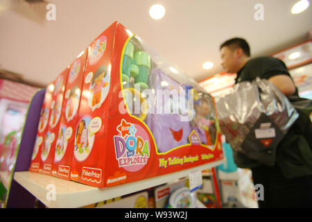 --FILE--A customer shops for Fisher-Price toys of Mattel at a store in Shanghai, China, 21 March 2013.   Mattel Inc. said it is looking into allegatio Stock Photo