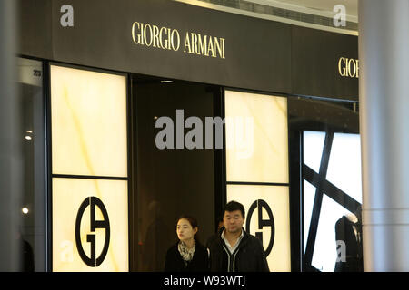 --FILE--Customers walk past the Giorgio Armani store at Plaza 66 in Shanghai, China, 21 November 2012.   Italian fashion house Giorgio Armani said Mon Stock Photo