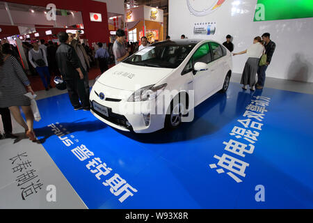 --FILE--Visitors look at a Toyota Prius Hybrid car during the Northeast Asia Investment and Trade Expo 2012 in Changchun city, northeast Chinas Jilin Stock Photo