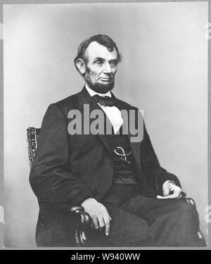 Abraham Lincoln, three-quarter length portrait, seated, facing right hair parted on Lincoln's right side Stock Photo