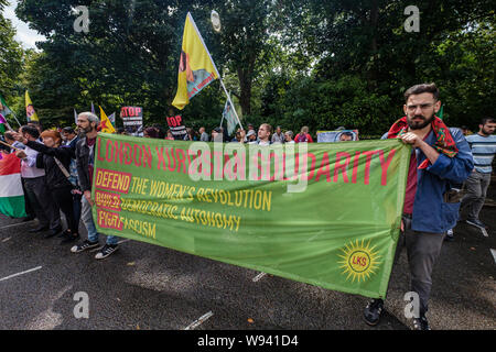 London, UK. 12th August 2019. Kurds and supporters protest at the Turkish Embassy over Turkish plans to invade Kurdish areas of eastern Syria with the aid of Syrian rebels including IS fighters. They accuse the fascist Turkish state of wanting to annihilate the Kurdish people and culture as well as the Kurdish People’s Protection Units which defeated IS. They want to destroy the autonomous Kurdish regions of Syria, a multi-ethnic democracy respecting the rights of women and minorities. Peter Marshall/Alamy Live News Stock Photo