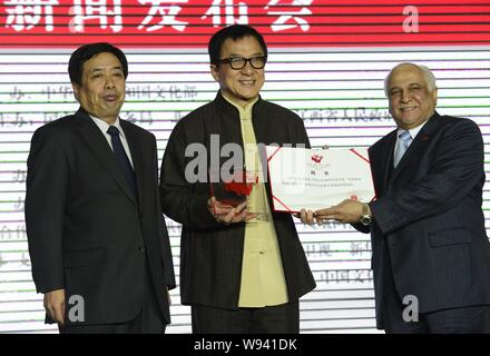 Hong Kong movie star Jackie Chan, center, receives as the appointment letter of the 2013 Chinese Cultural Ambassador of Saudi during the opening cerem Stock Photo