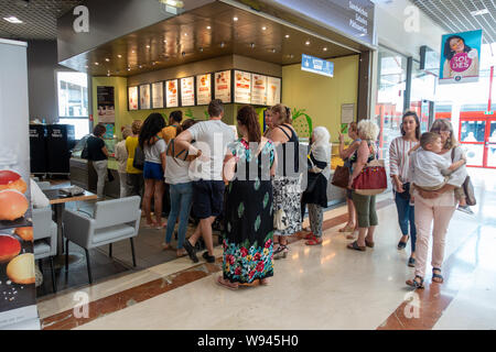 People queue for food at the French Flunch food outlet in a shopping mall in Beziers Stock Photo